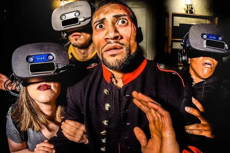 Actor surrounded by audience members in VR headsets.