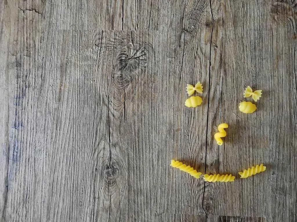 Smiley face made out of different type of pasta.