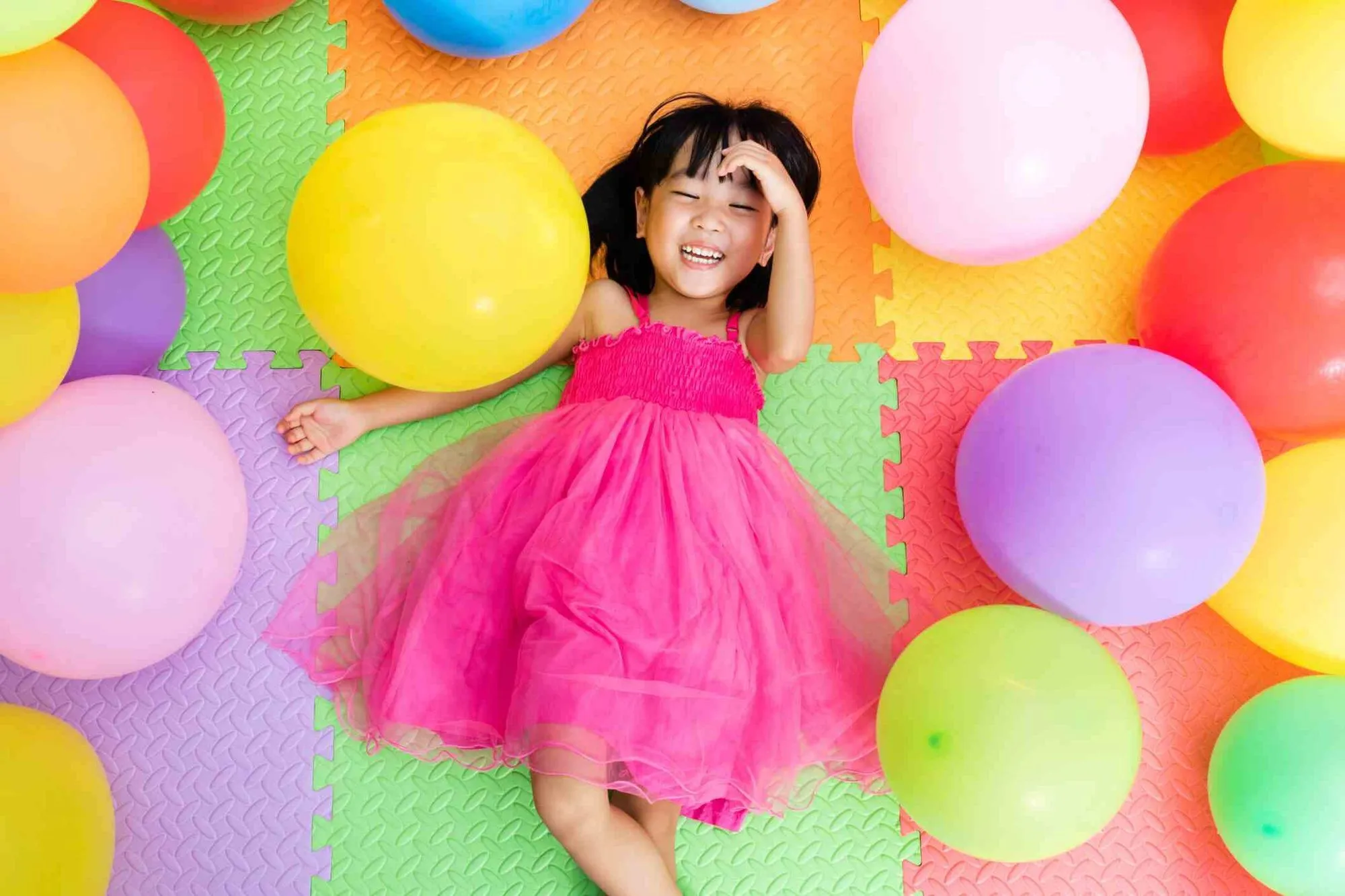 Girl surrounded by balloons.