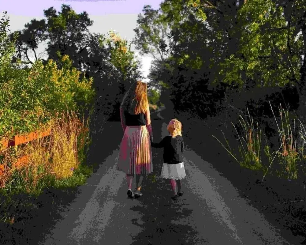 Mother and daughter walking in the woods