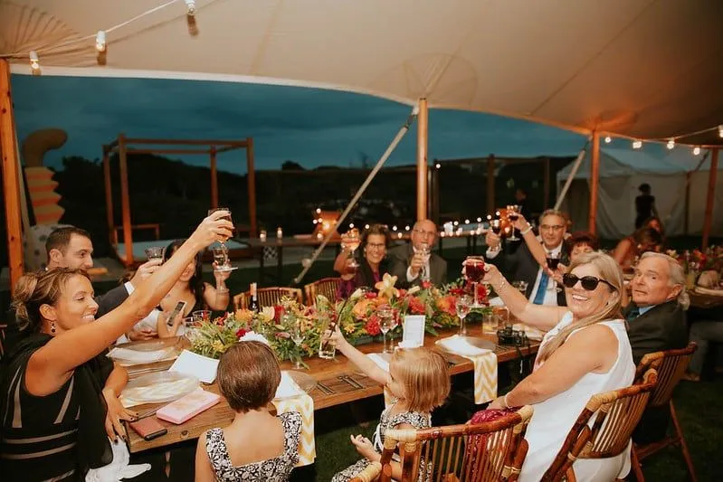 Family happy and smiling eating outdoors at a restaurant.