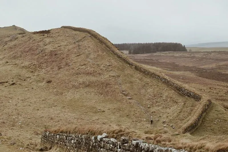 A walker in the distance walking alongside Hadrian's Wall. 