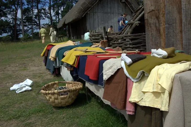 Anglo-Saxon style clothing laid out on a table in front of the huts in the Anglo-Saxon village.