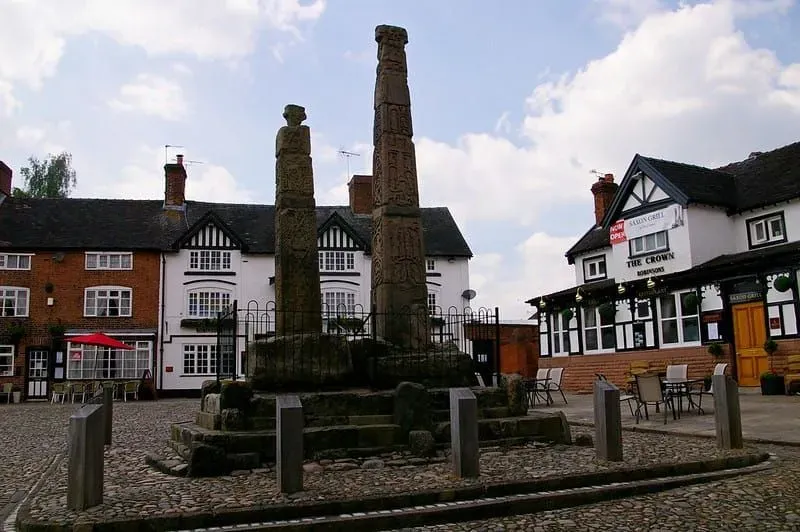 Town square in England with a pub in the corner and an Anglo-Saxon statue in the centre. 