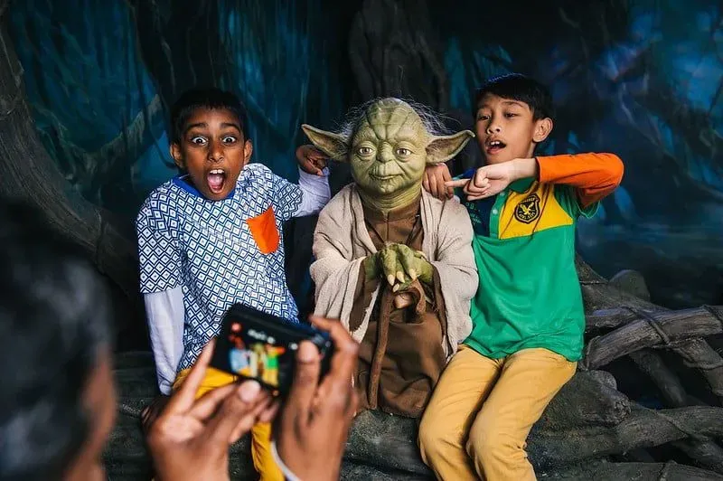 Two children with the Yoda waxwork at Madame Tussauds.