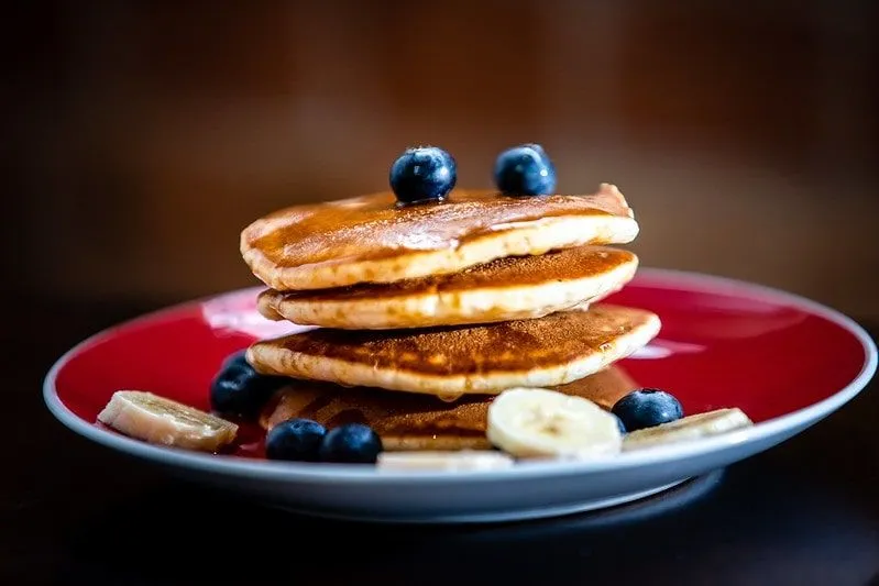 Stack of pancakes with blueberries and banana.