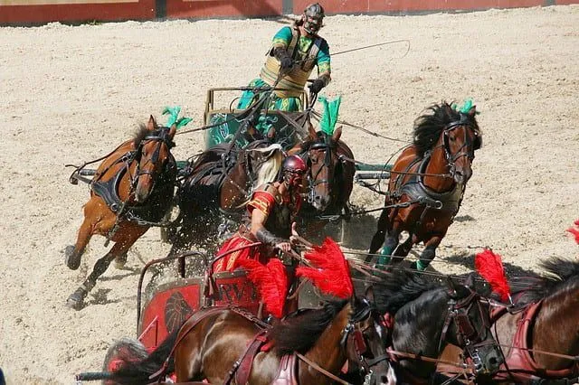 A Roman chariot race, two chariot drivers are close to each other.