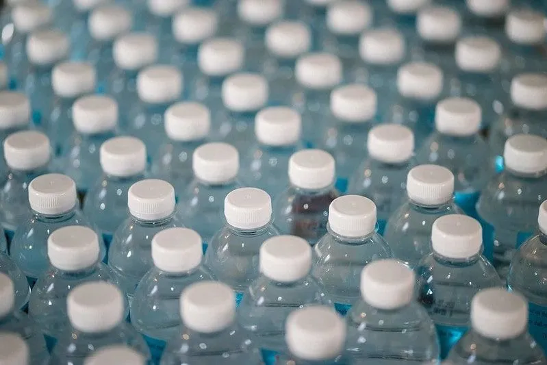 Stock of many plastic water bottles.