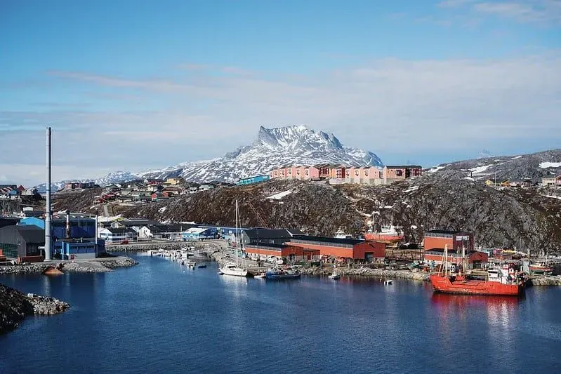 View of the capital city, Nuuk, with a port in front and a mountain behind.