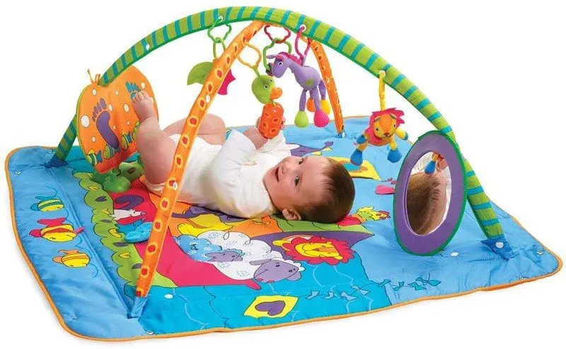 Baby playing with Tiny Love Gymini Kick And Play Mat.