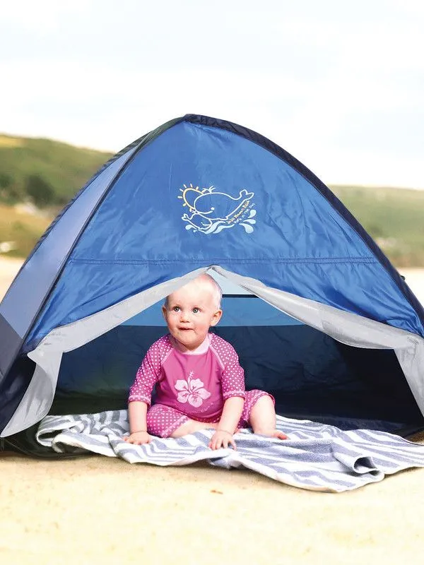 Baby sitting in an Infant Sun Protection Tent.