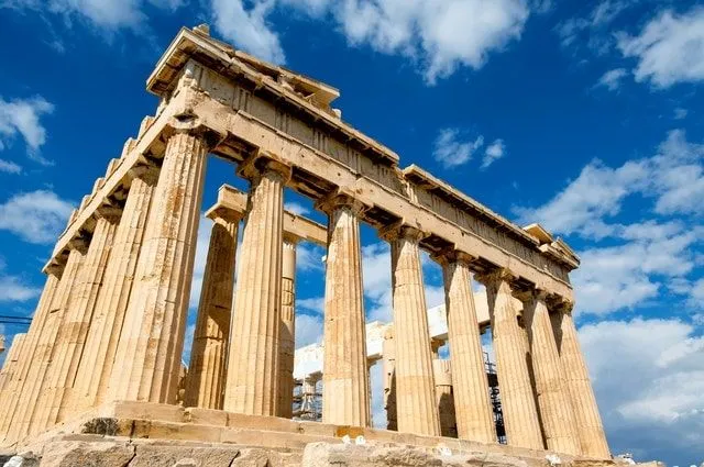 The Parthenon, Athens, Greece, on a sunny day with blue sky behind it.