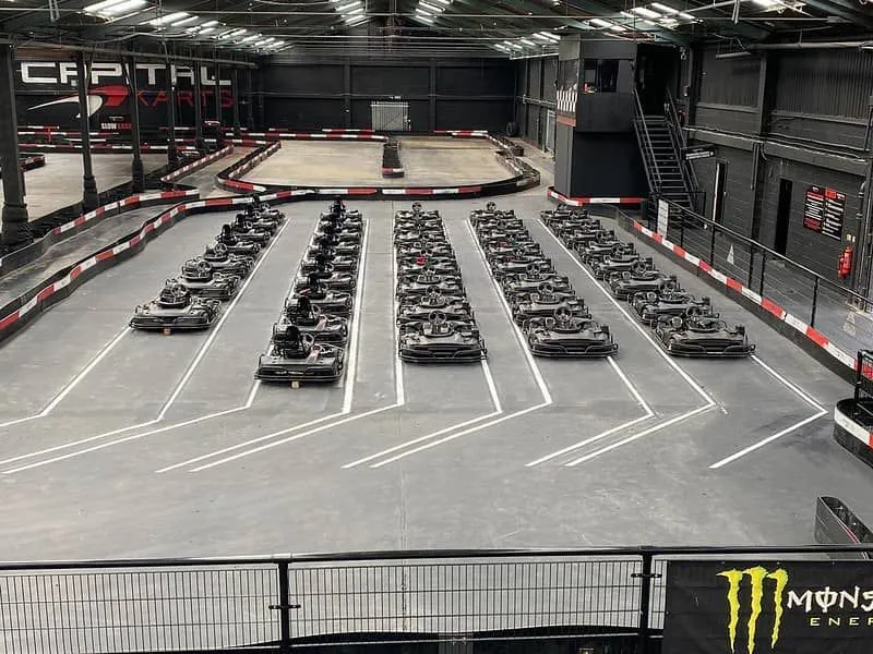 Indoor go-karting course at Capital Karts has go-karts all lined up ready to go.