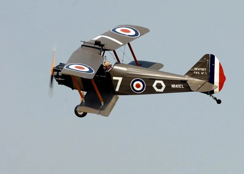A World War 1 RAF plane flying through the sky.
