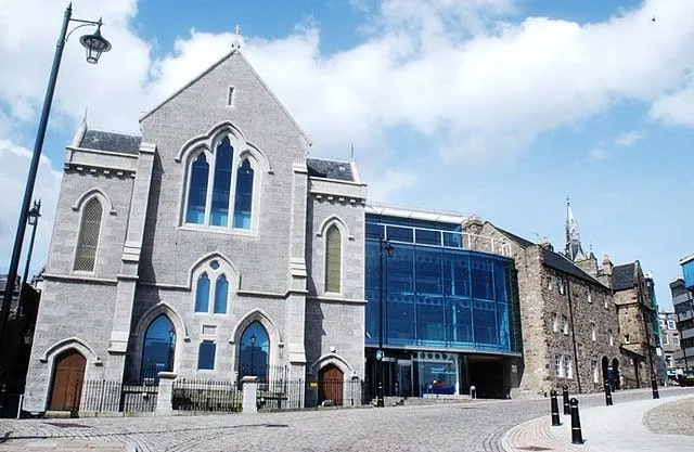 The outside of the Aberdeen Maritime Museum, a grey building with blue glass windows.