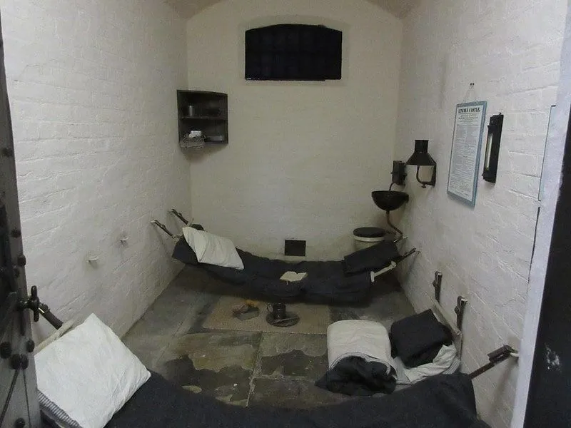 A cell in a Victorian prison with 3 mattresses in a single cell.