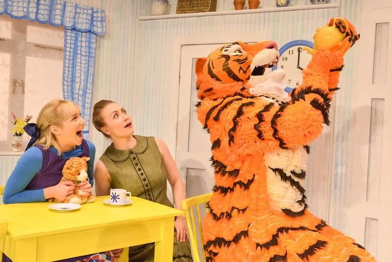 The Tiger Who Came to Tea drinking from a teapot on stage.