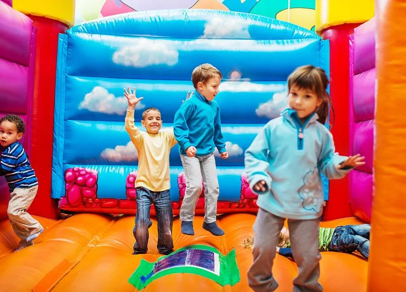 Group of children enjoying while playing in the bouncy castle