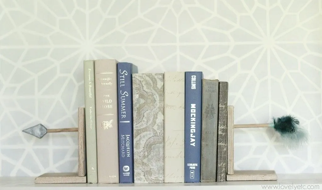 Half of an arrow stuck onto bookends to look like the books have been shot through the middle.