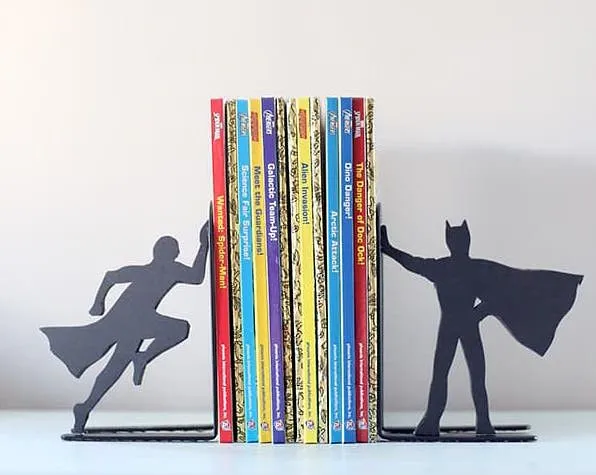 A shadow figurine of Superman and Batman on each bookend.