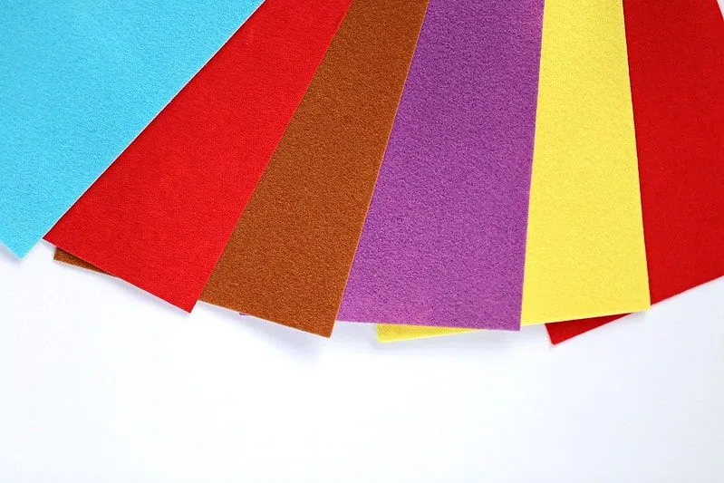 Different colours of felt paper fanned out.