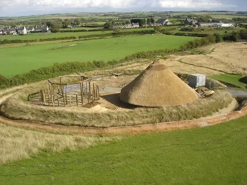 A Celtic roundhouse in the countryside.