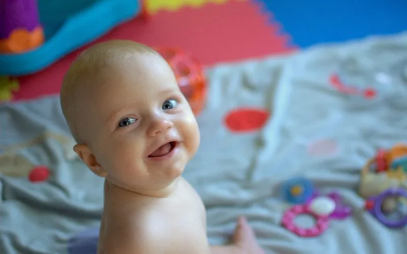 Baby smiling on playmat