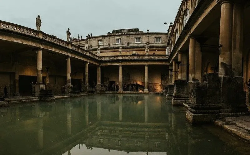 The main bath at the Roman baths, surrounded by a colonnade.