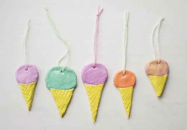 Ice cream cones made from salt dough with a string tied through the top for hanging.