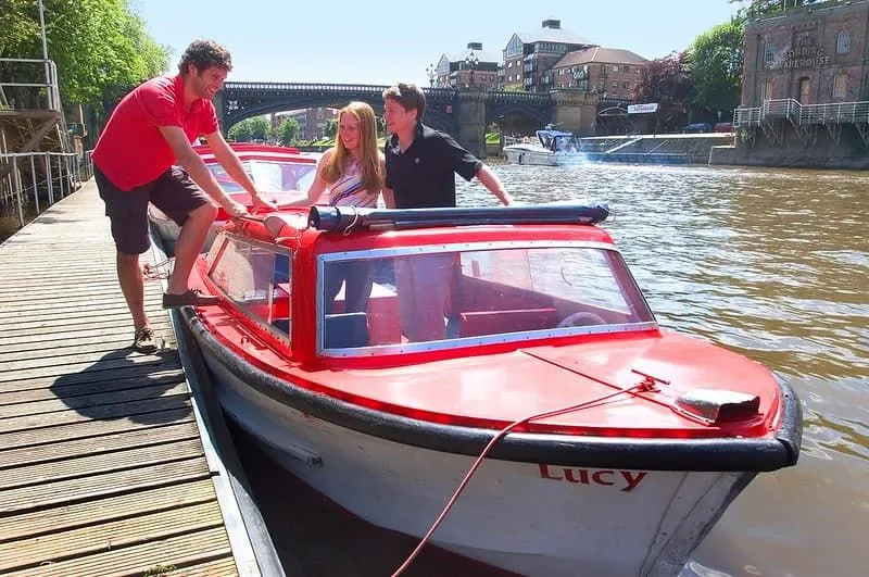A couple and a skipper in the City Cruises York self-drive boat. 