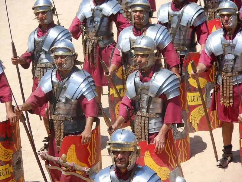 Group of men in Roman soldier armour marching.
