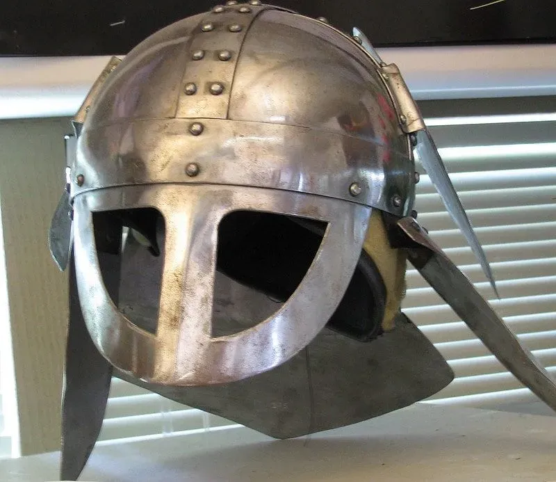 Viking mask helmet made out of silver metal.