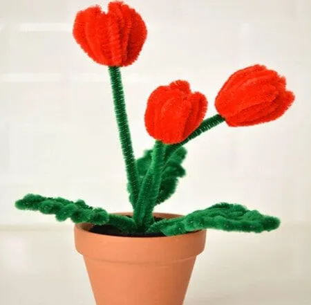 Flower pot of three red pipe cleaner tulips.