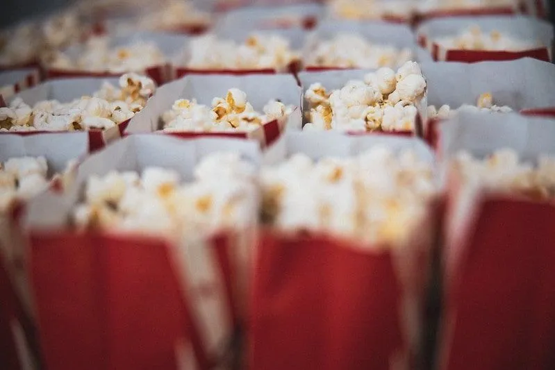 Red bags of popcorn lined up next to one another at the cinema.
