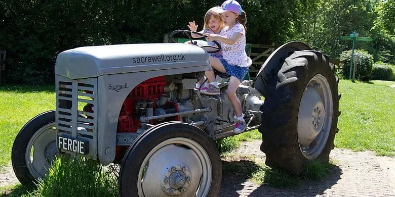 Two girls on a tractor at Sacrewell Farm.