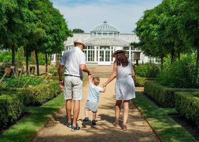 Parents and young son visiting a beautiful garden on a family day out in Tamworth.