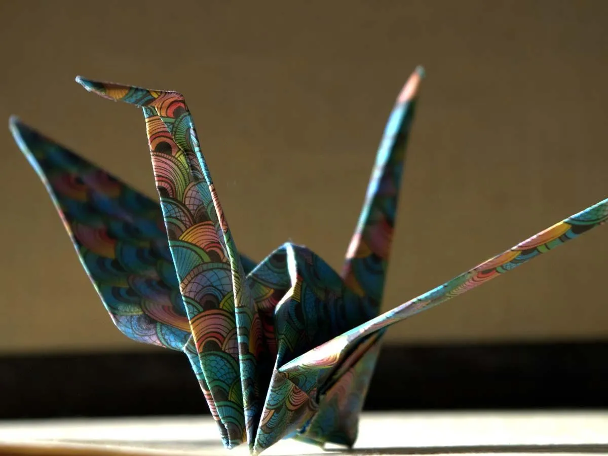 Origami swan made with a colourful, patterned paper.