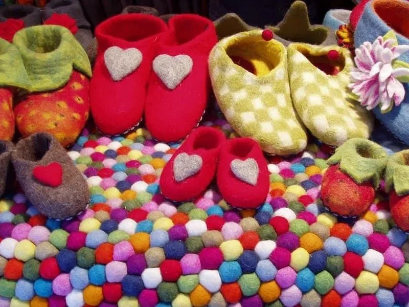 Pairs of felt shoes with decorations.