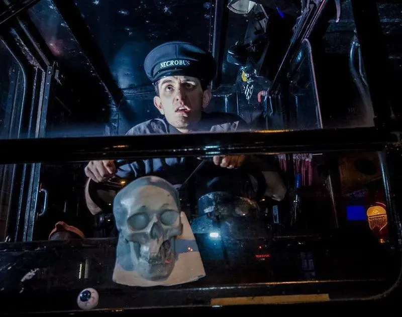 An actor conductor at the wheel of the Ghost Bus Tour Edinburgh looking scared.