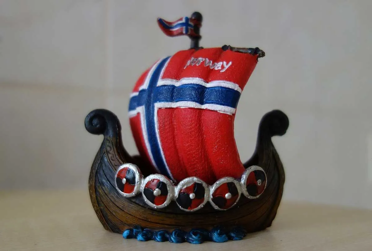 A miniature model Viking longboat with the Norwegian flag as the sails.