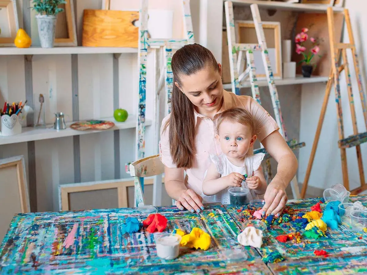 Mum and toddler sat at the table with art supplies ready to make a unicorn horn.