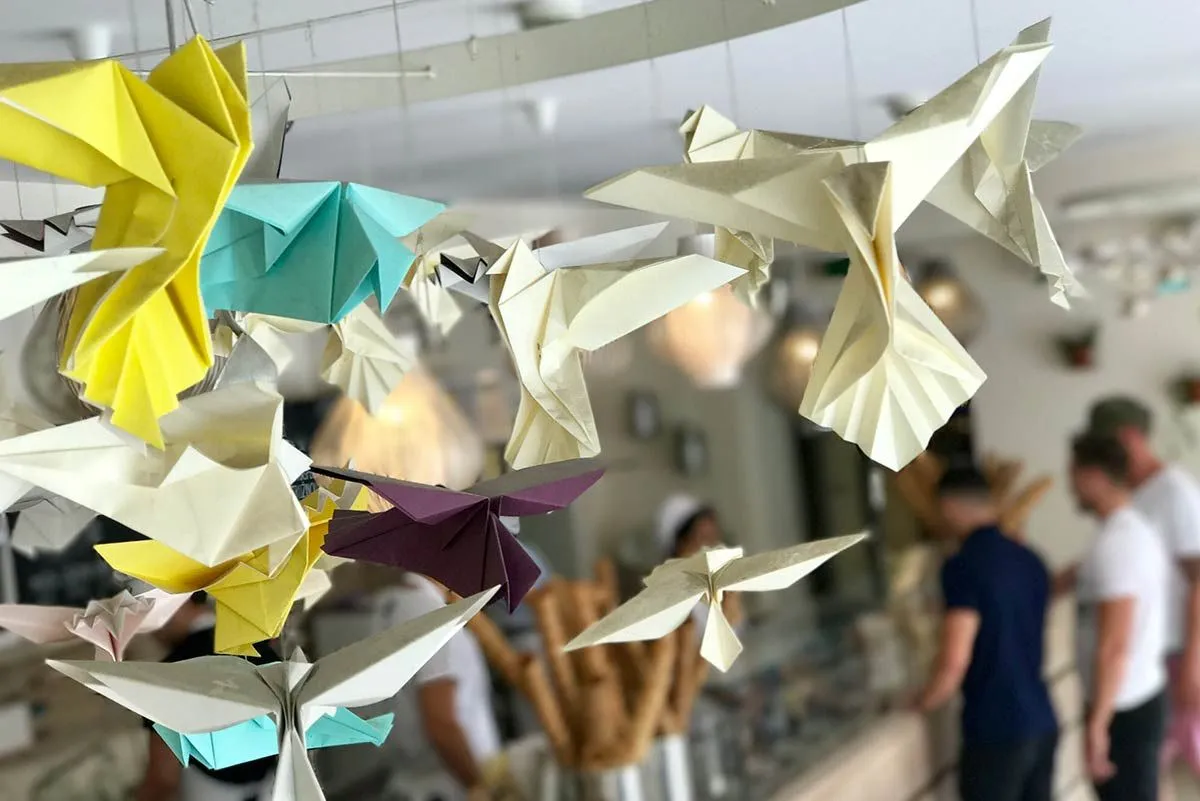 Some origami swallows hanging from the ceiling.