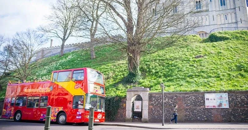 An open-top double-decker sightseeing bus at at Castle Meadow in Norwich. 