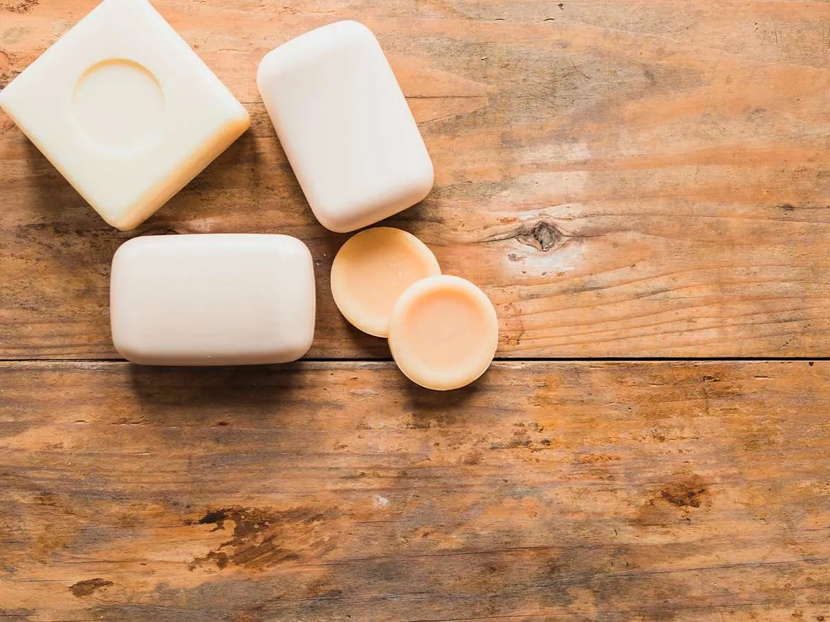 Bars of soap, all different shapes and sizes, for kids on a wooden table.