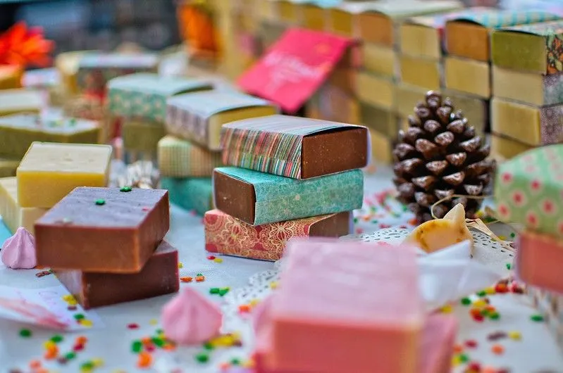 Lots of colourful bars of organic soap for kids, wrapped in patterned paper.