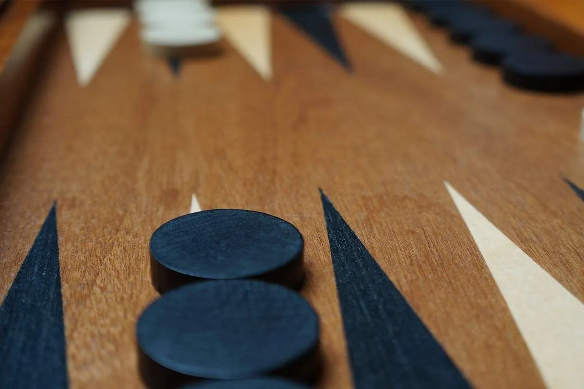 Close up of the backgammon board and the checkers on it.