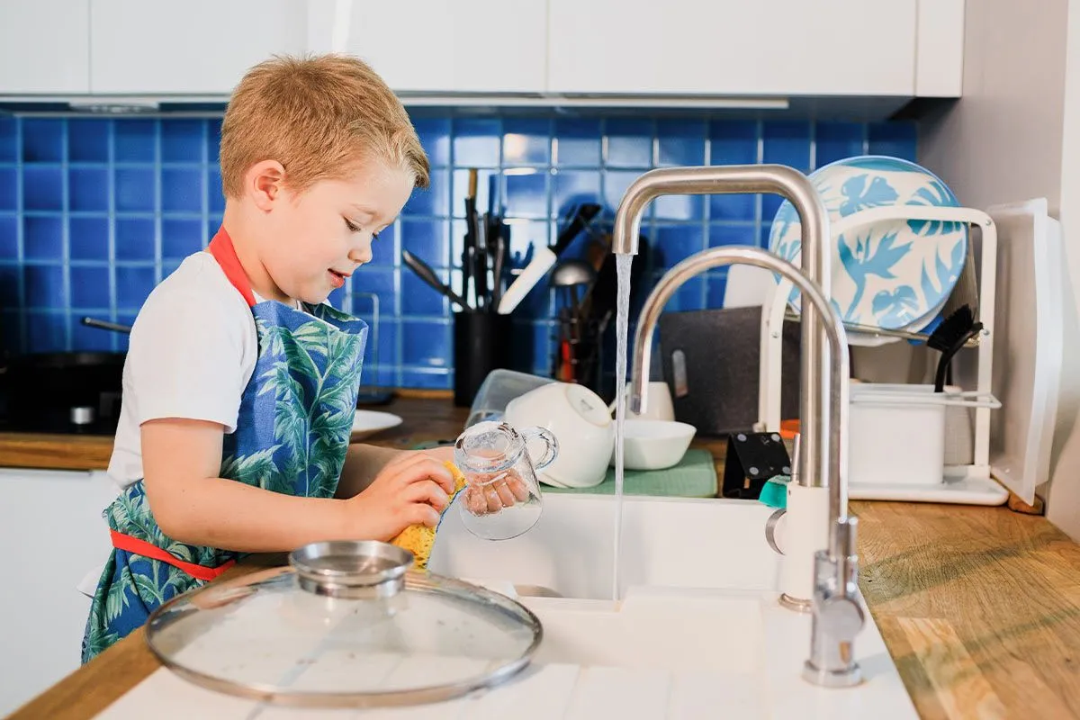Мальчик моет посуду. Мальчик на кухне. Мытье посуды для детей. Мальчик помыл посуду.