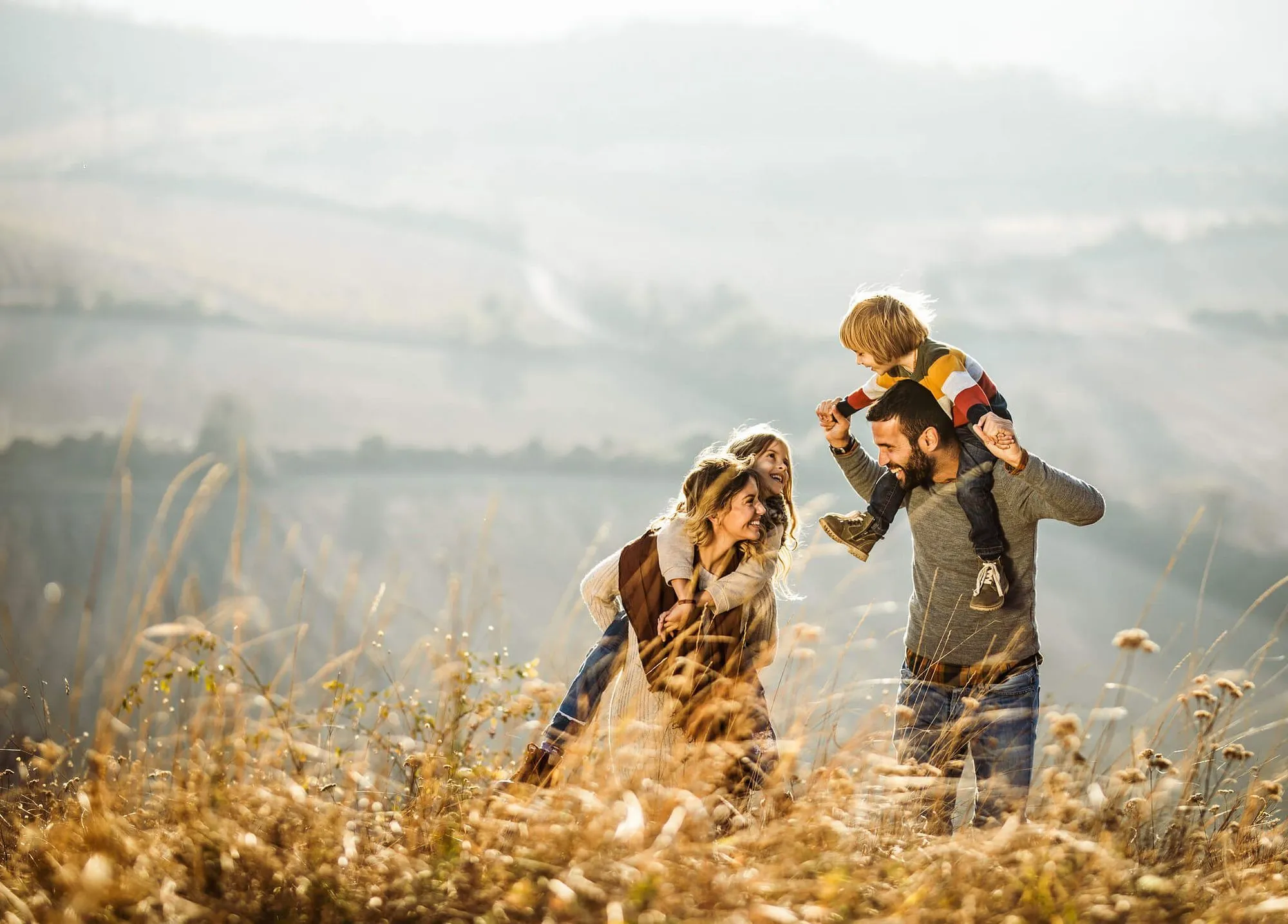 Family walking in the countryside on a hill