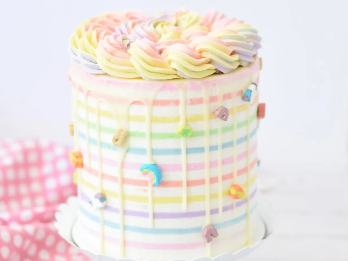 Multi pastel-coloured birthday cake decorated with rainbow sprinkles.