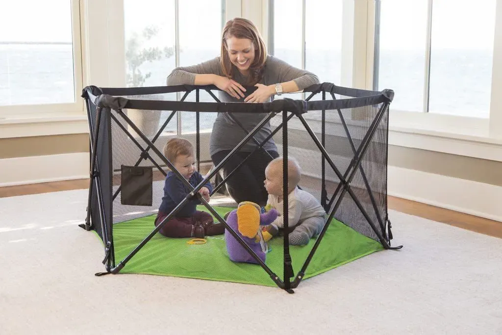 Two babies play under supervision in the Summer Infant Pop 'N Play Playpen.